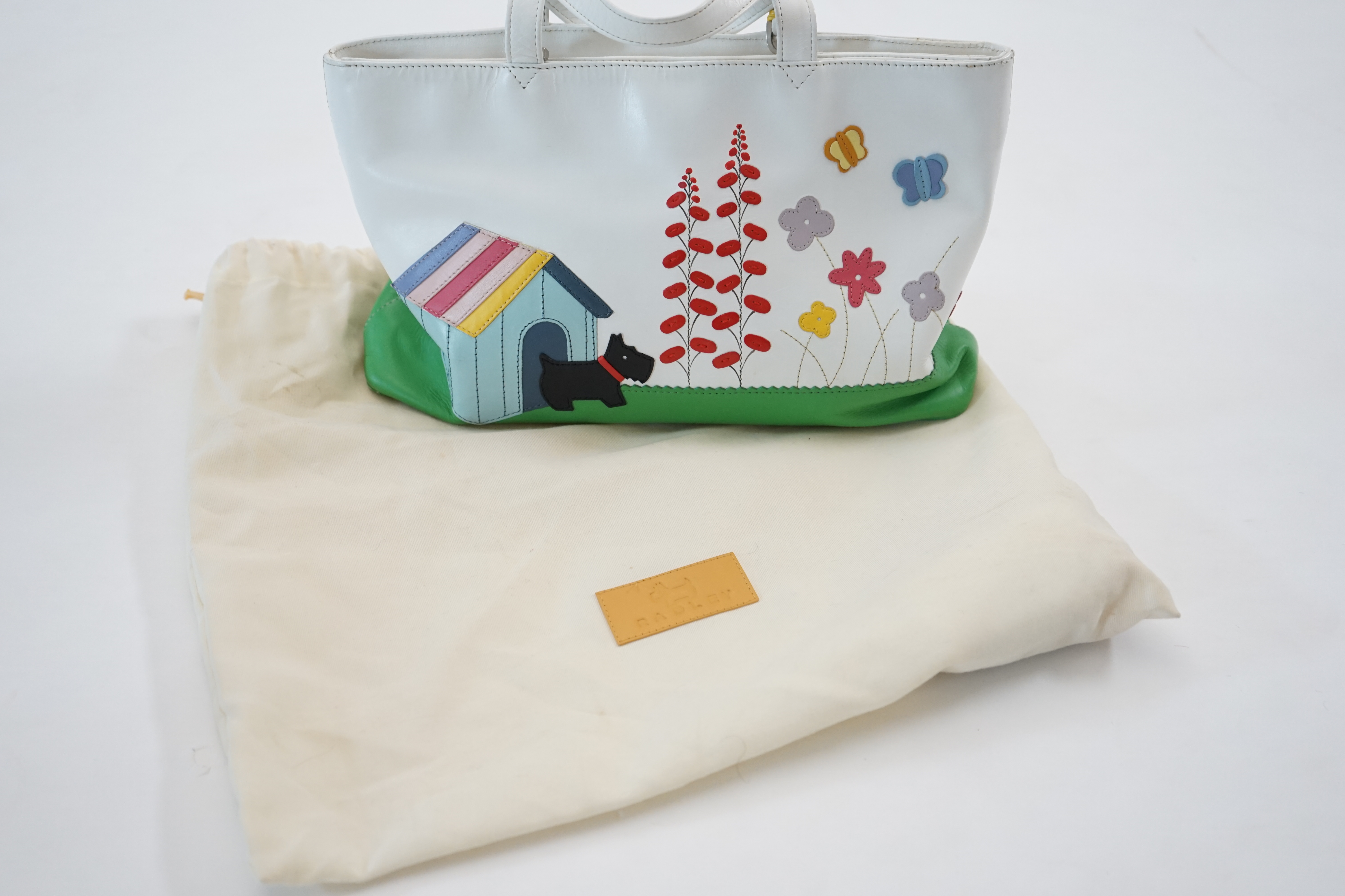 A Radley white 'Radley's Garden' leather grab bag 2004, width 30cm, depth 8cm, height 18cm